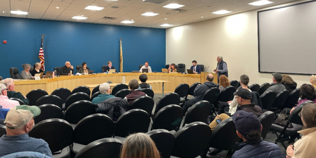 people sitting together for a council meeting in progress