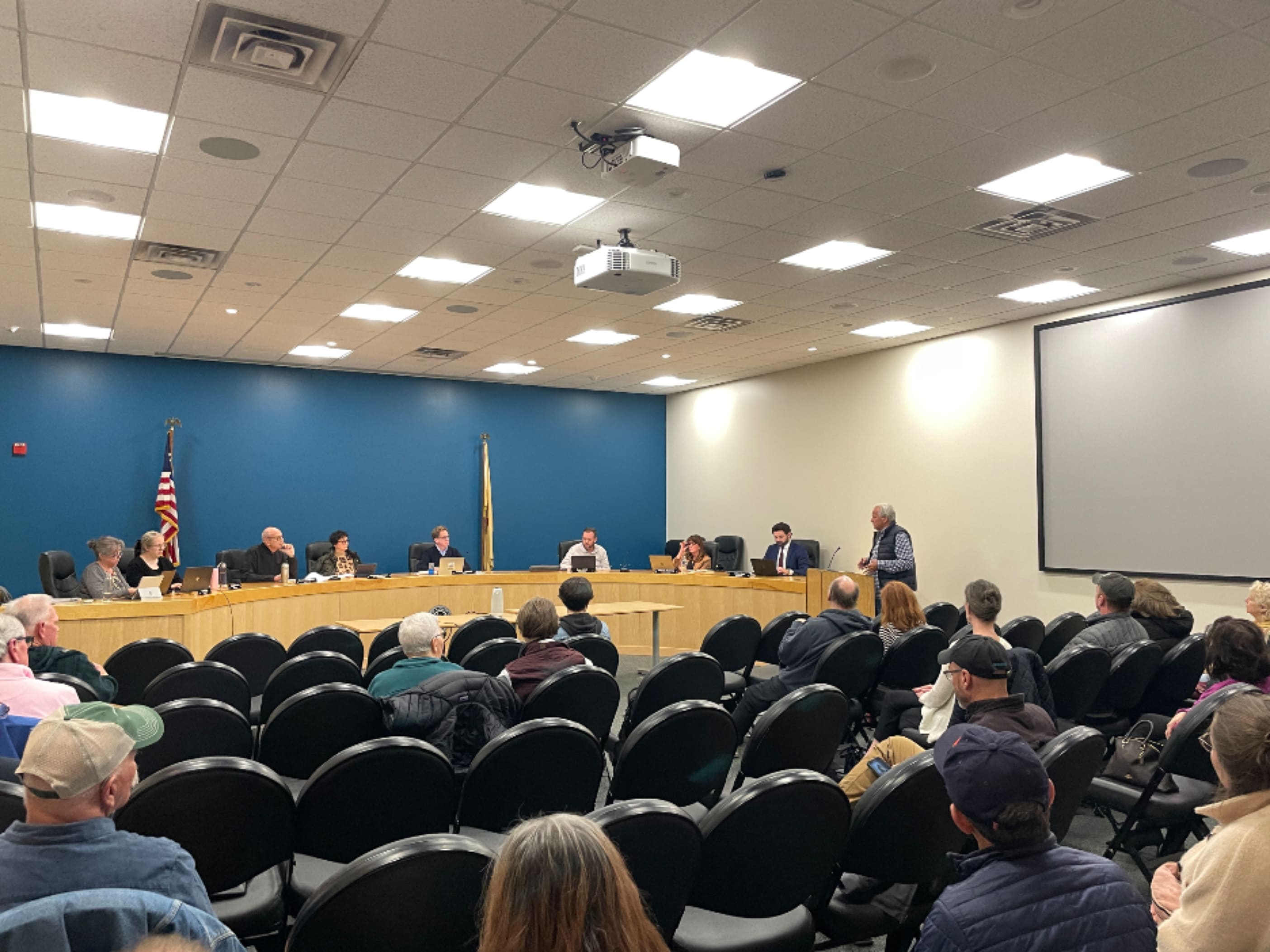 people sitting together for a council meeting in progress