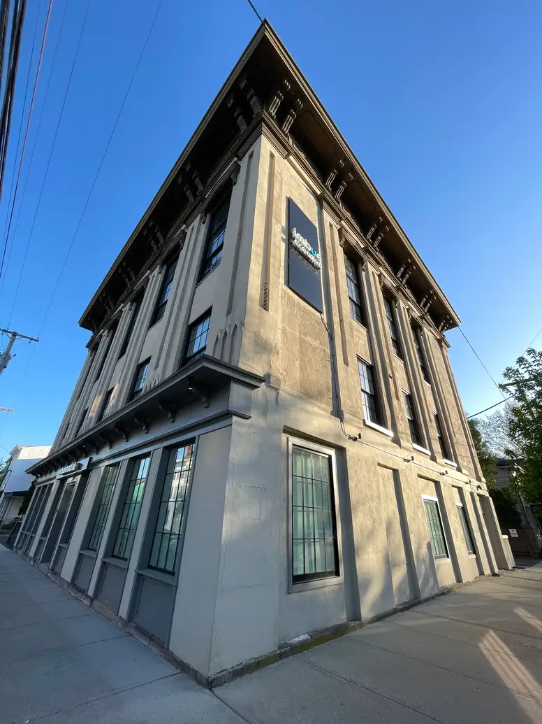 a tall, dramatic building with an overhanging roof