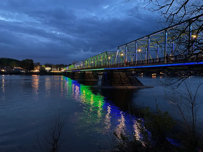 the bridge at dusk with colored lights lining the edges