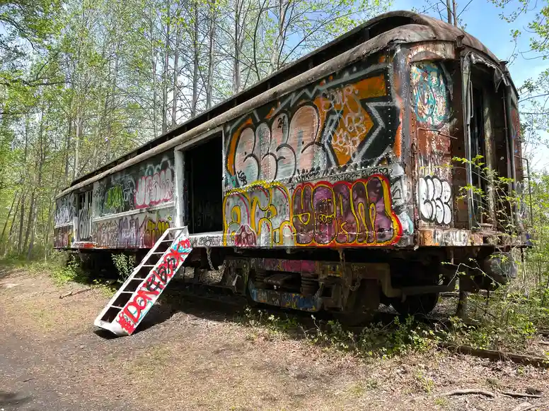 an old train car covered with graffiti markings
