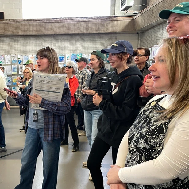 people with surprised, attentive expressioins on their faces