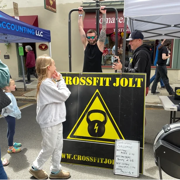 a man hangs by his hands from a bar