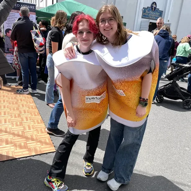 two young people dressed as glasses of beer