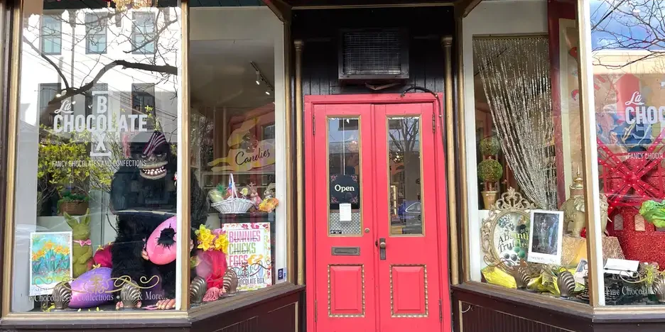a whimiscal storefront window at La Chocolate Box features a fun gorilla with ShadFest posters on display