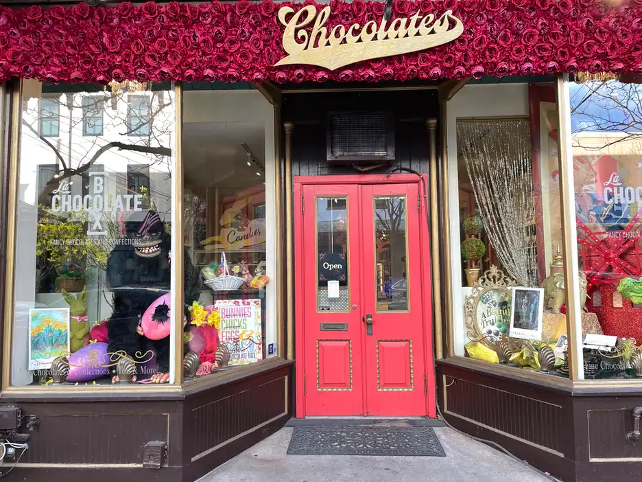 a whimiscal storefront window at La Chocolate Box features a fun gorilla with ShadFest posters on display