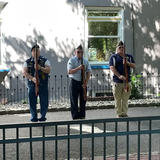 veterans holding rifiles at attention