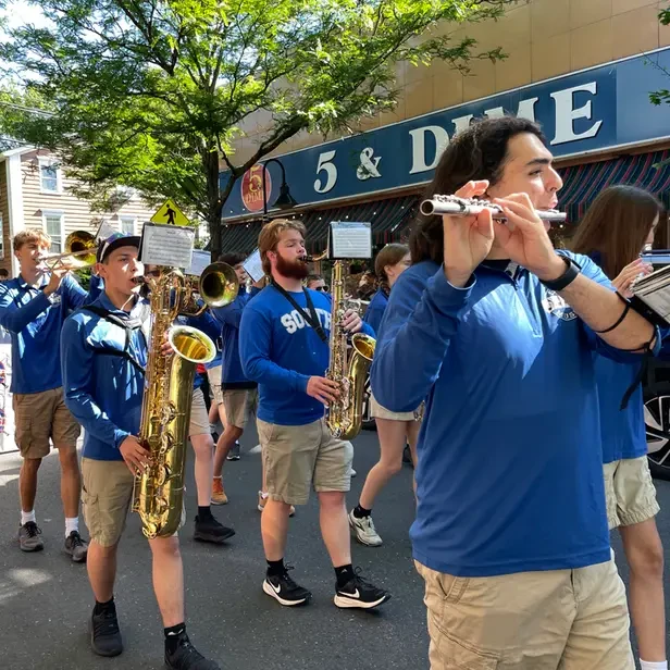 high school marching band walking down union street