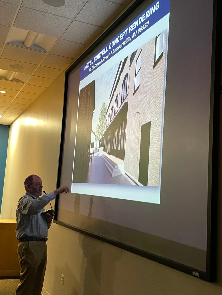 Connors standing in front of a screen looking up at a projected image