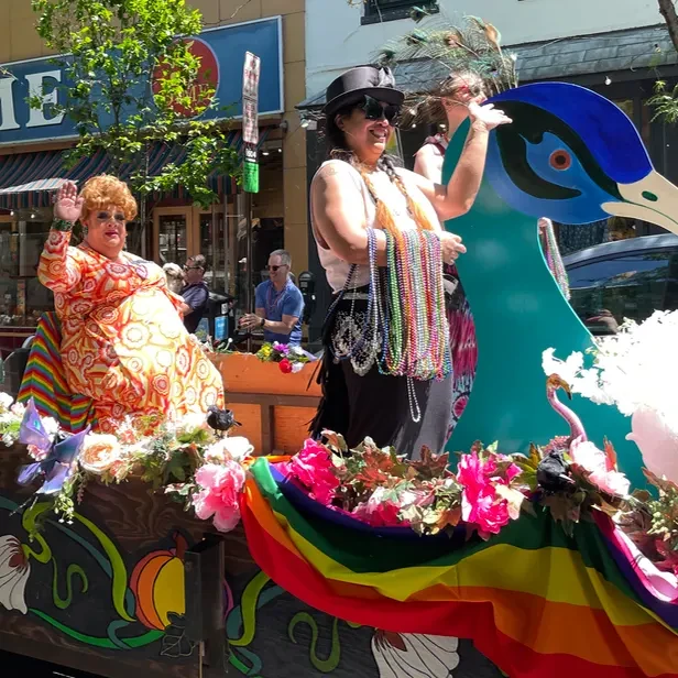 Miss Pumpkins waves as she rides on the back of a parade float