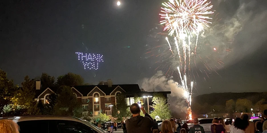 fireworks and drones in the night sky