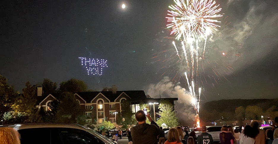 fireworks and drones in the night sky