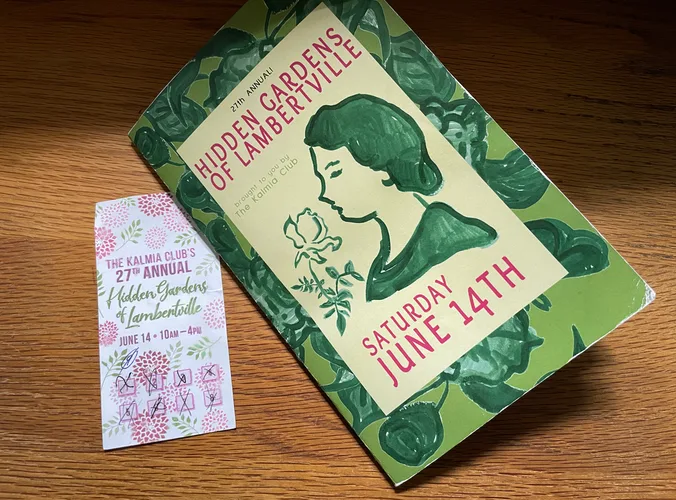 a paper booklet with a paper ticket by its side on a desk