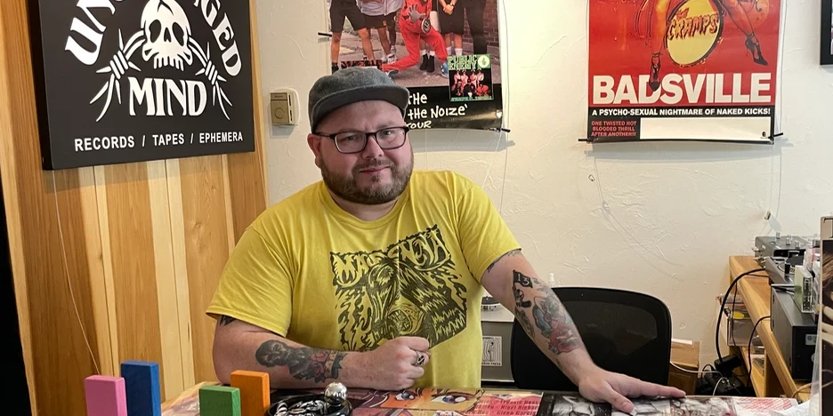 Jake standing behind the counter at his record store in Lambertville