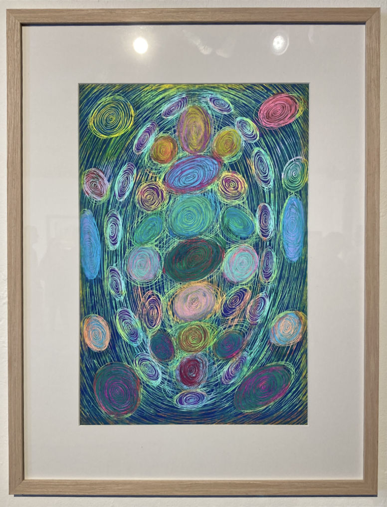 a framed work of art with many hand drawn circles and varying colors