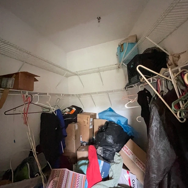 boxes and clothes piled in the walk-in closet