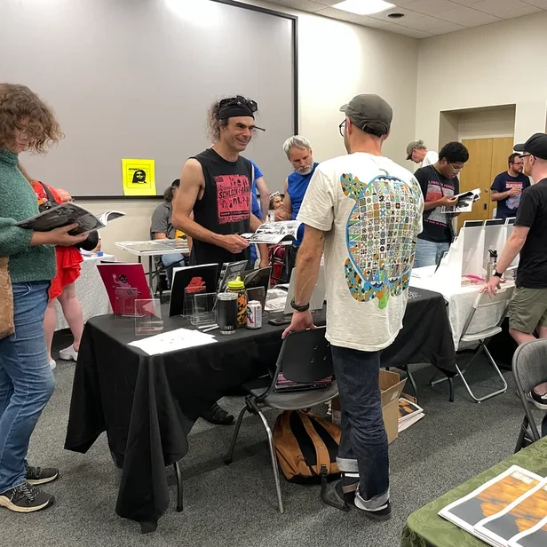 Jacques talking to a tabler at the conference