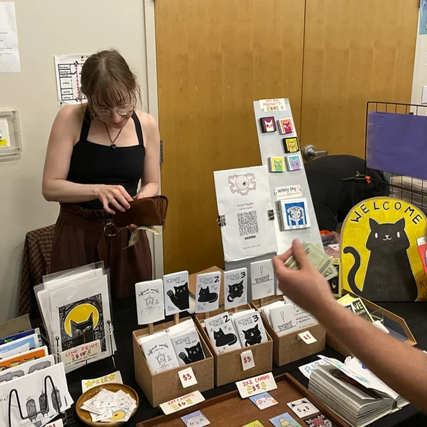 Anita giving change to a customer