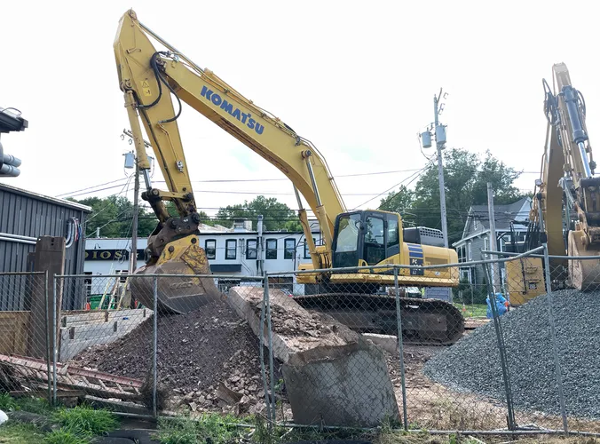 a large tractor parked next to a construction site