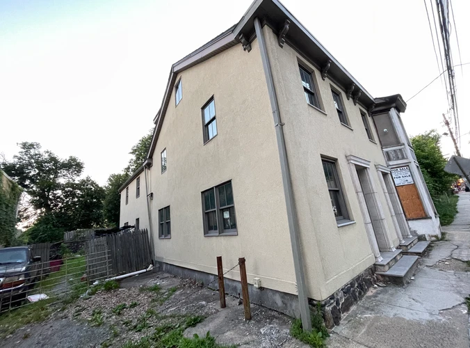 an old building with a for sale sign on it