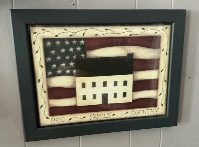 a framed folk art work that says “God, Family, Country” 