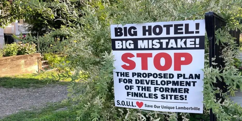 a sign that reads, "big hotel! big mistake! stop the proposed plan for development of the former finkles sights! S.O.U.L. save our unique lambertville"