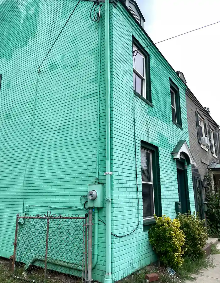 a brick house painted turquoise