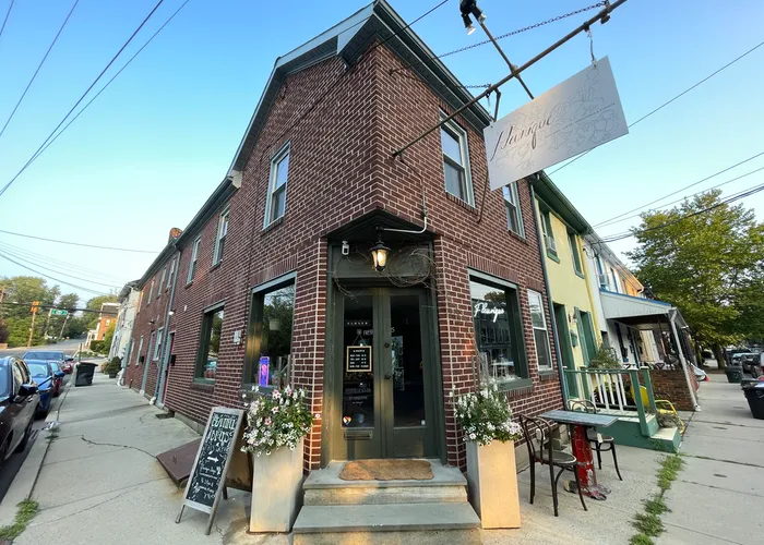 a mixed use brick building with a florist on the first floor and an apartment above