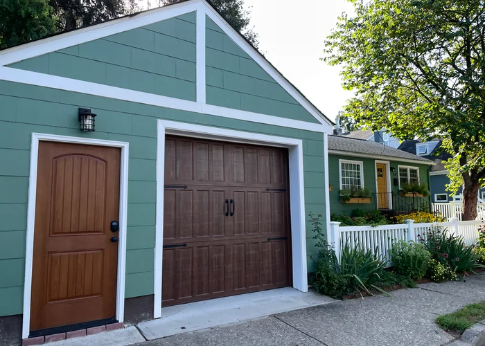 a tiny cottage with a separate garage