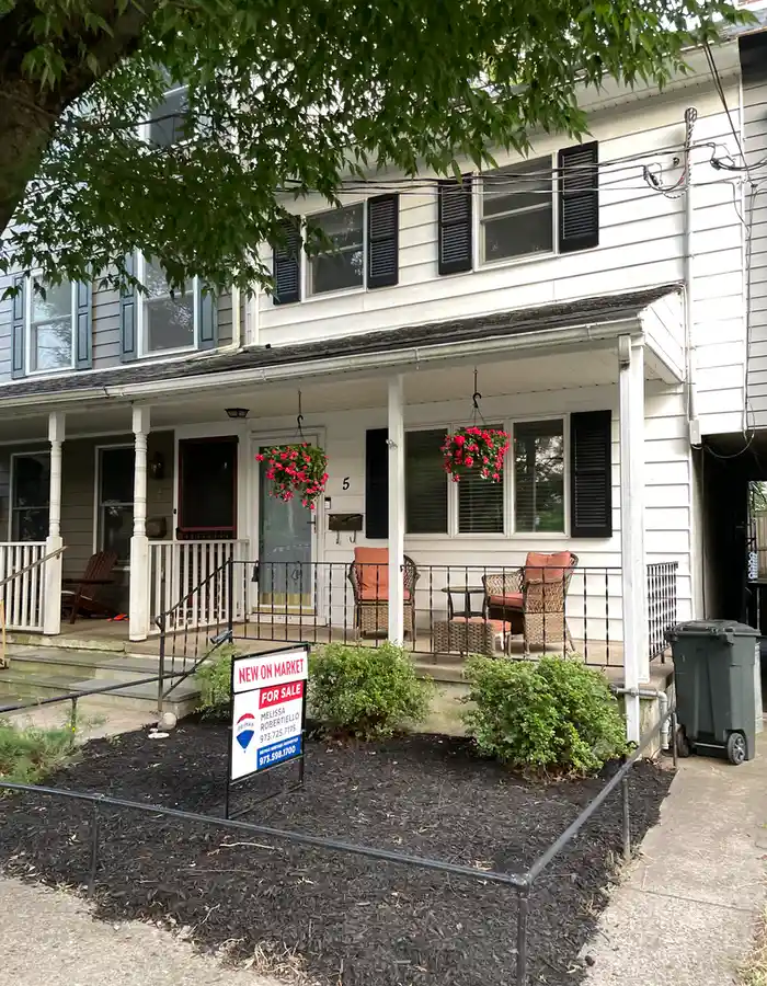 a semi-attached house with a front porch and aluminium siding