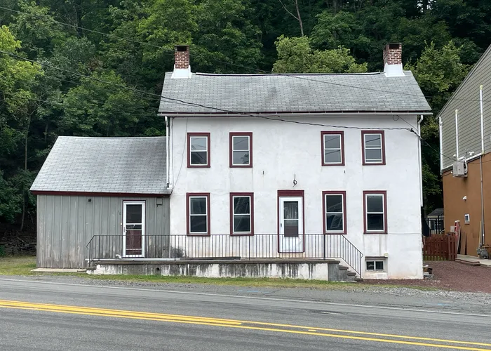 an old house on the edge of a busy street