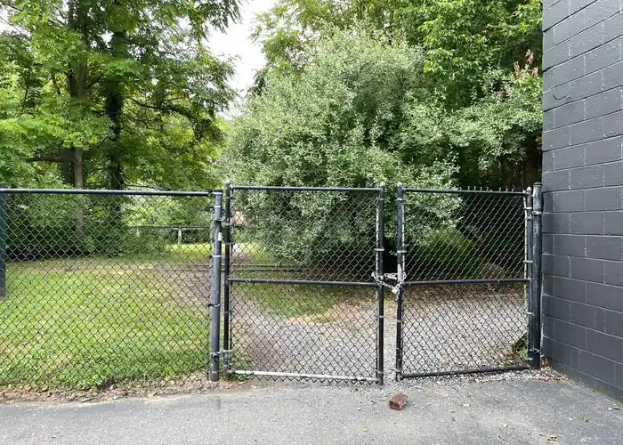 a fence with a chain and lock around the closed gate