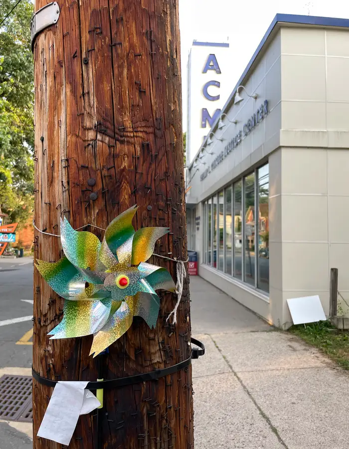 a colorful spinner attached to a phone pole