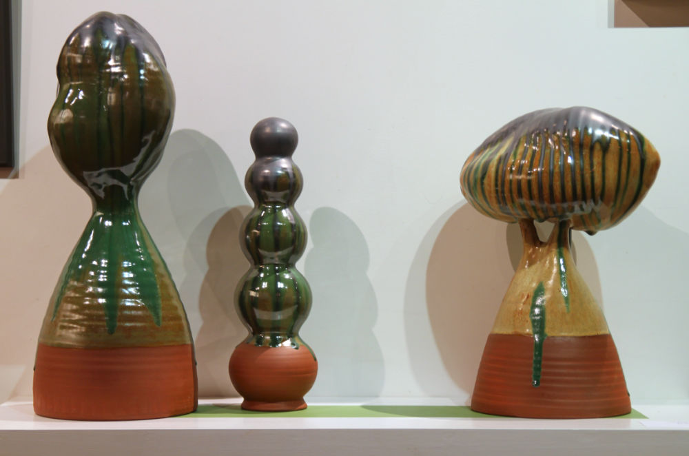 three handmade ceramic sculptures that are round and tall with varying waves of circumferance from top to bottom