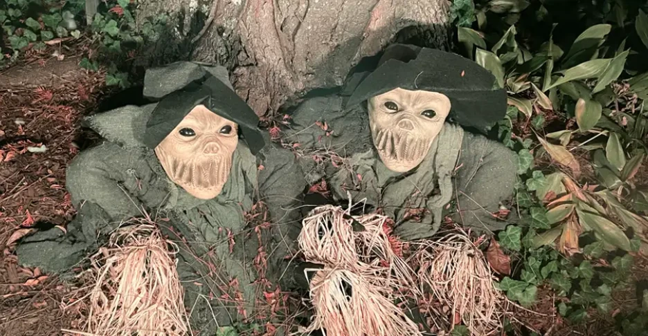 two haunted scarecrows coming up out of the ground