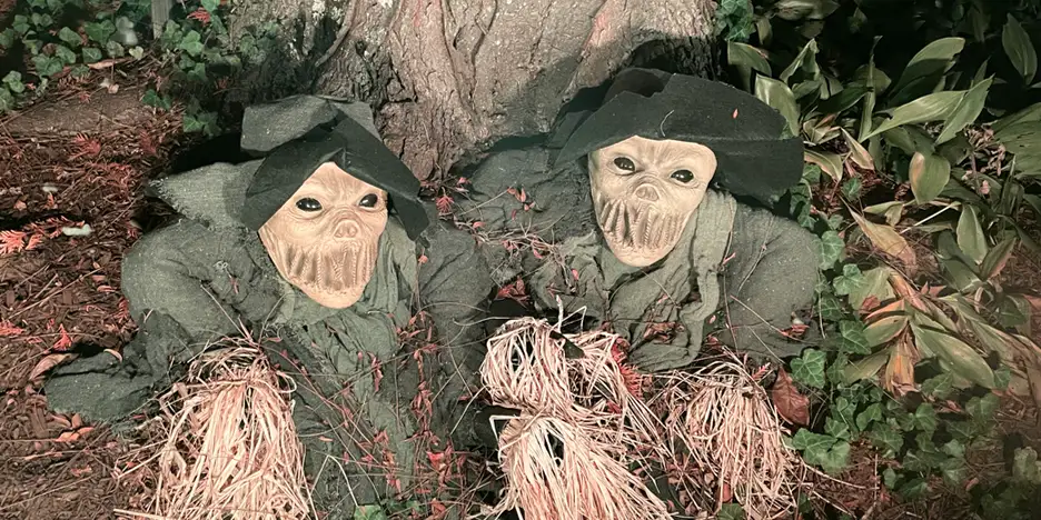 two haunted scarecrows coming up out of the ground