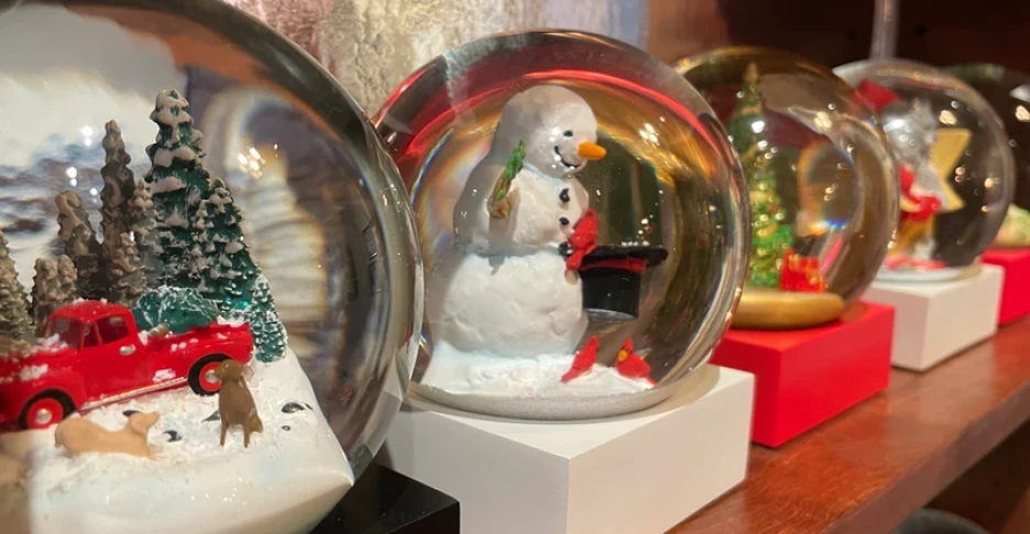 Christmas snow globes on a shelf
