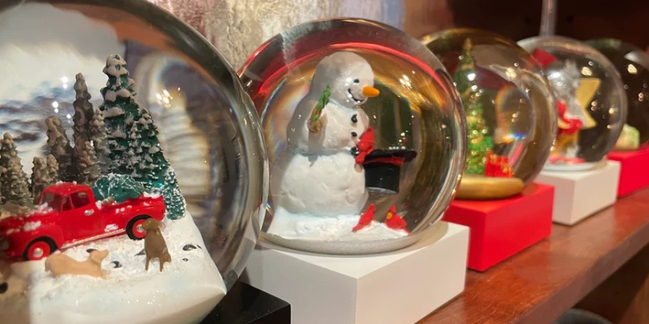 Christmas snow globes on a shelf