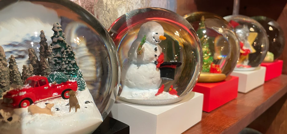 Christmas snow globes on a shelf