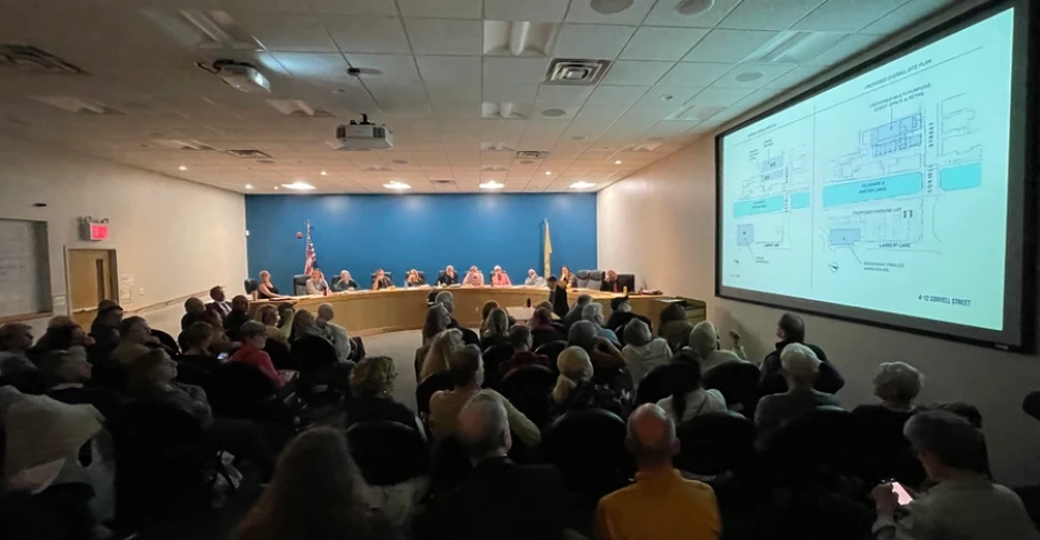 a meeting room filled with people looking at a projected image on a screen