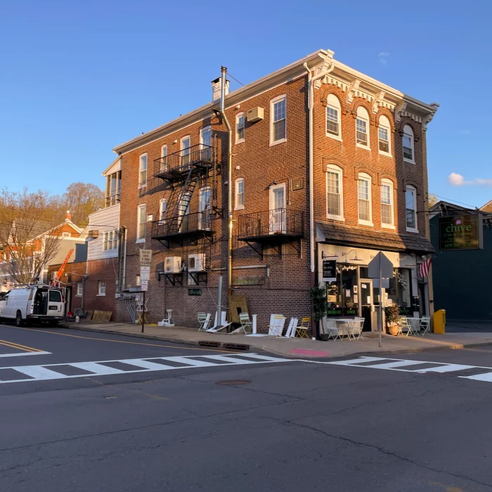 a multi-story brick building with a restaurant on the first floor