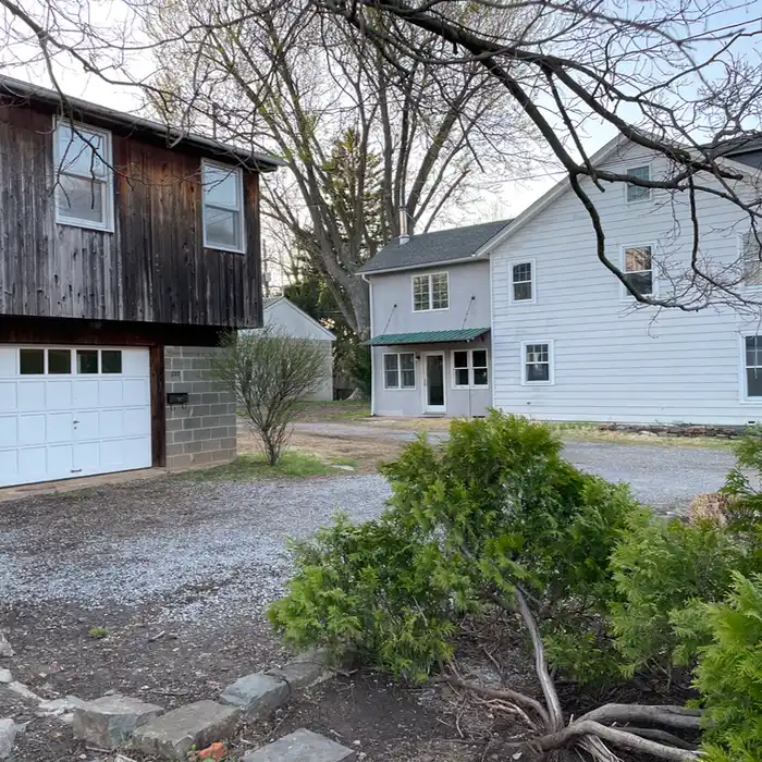 a double garage with an apartment above and a separate house nearby