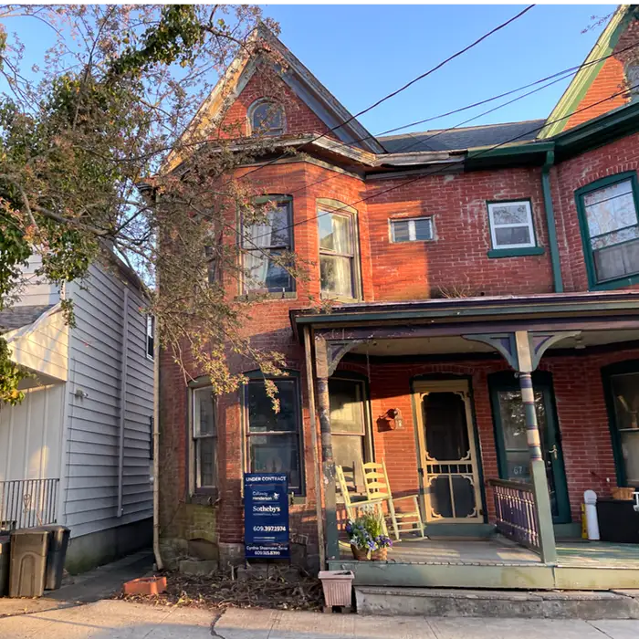 an old brick house with a front porch