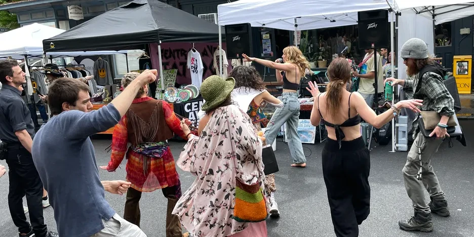people dancing on the street at a festival