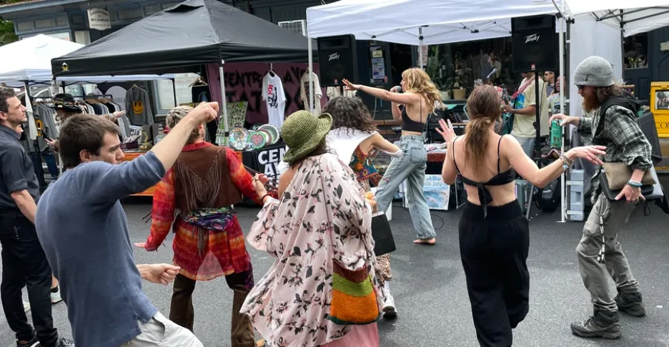 people dancing on the street at a festival